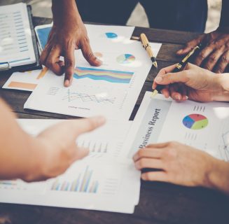 Group of business people analysis with marketing report graph, Young specialists are discussing business ideas for new digital start up project.